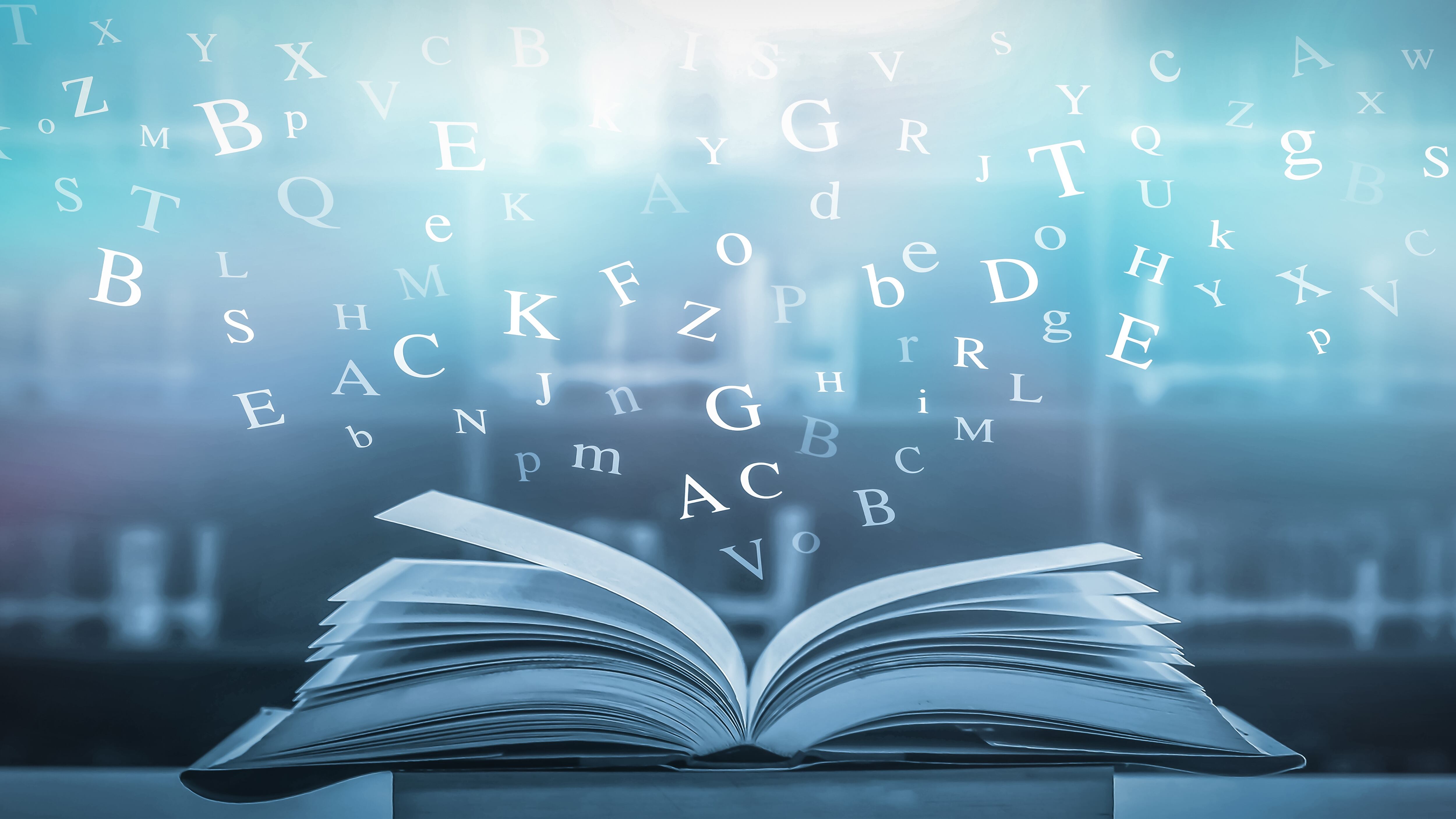 Dictionary with letters flying out concept